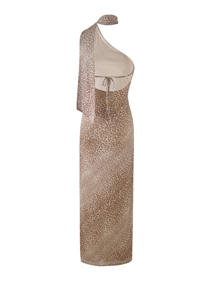 The TIGERMIST ALLIRA MAXI DRESS - NEUTRAL : LEOPARD is a sleeveless, one-shoulder fitted maxi dress in a beige leopard print, featuring an asymmetrical neckline, under-bust tie detail, stretchy fabric for comfort, and draped fabric over one shoulder.