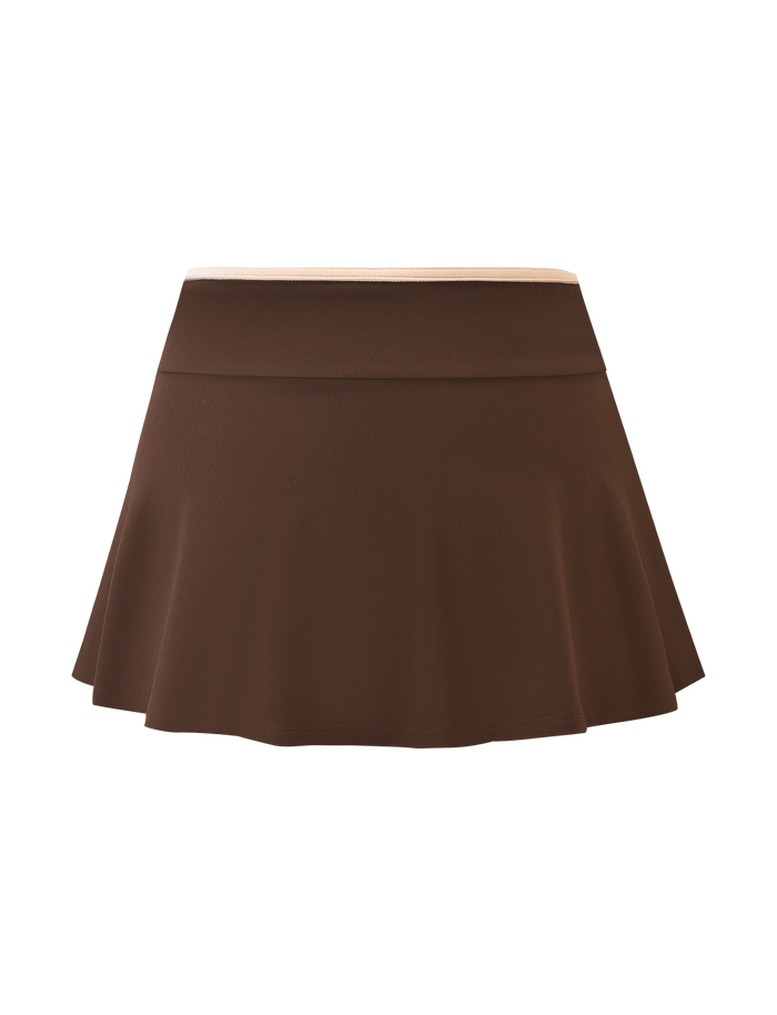 The TIGERMIST ALYSIA SKORT - CHOCOLATE is a brown, high-waisted A-line mini skort with a flared silhouette and built-in shorts, shown against a plain background.