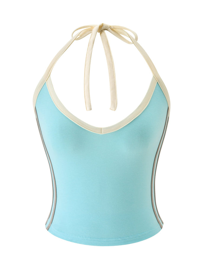 The ALYSIA TOP - AQUA by TIGERMIST is a women’s jersey top in aqua blue, designed with a halter neck, cream-colored trim and straps, a V-neckline, and a fitted silhouette. Vertical gray stripes accent each side.