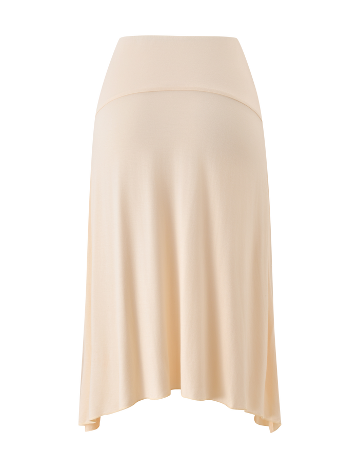 The TIGERMIST ALYSSA HI LO SKIRT in cream is a light beige, knee-length maternity skirt with a wide fold-over waistband and chic front slit, shown against a white background.