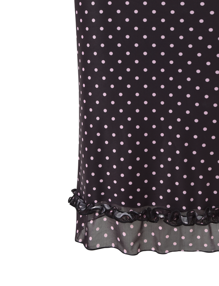Close-up of the AMARA MIDI SKIRT - BLACK by TIGERMIST, featuring light pink polka dots, a ruffled hemline, and delicate lace trim, displayed against a white background.