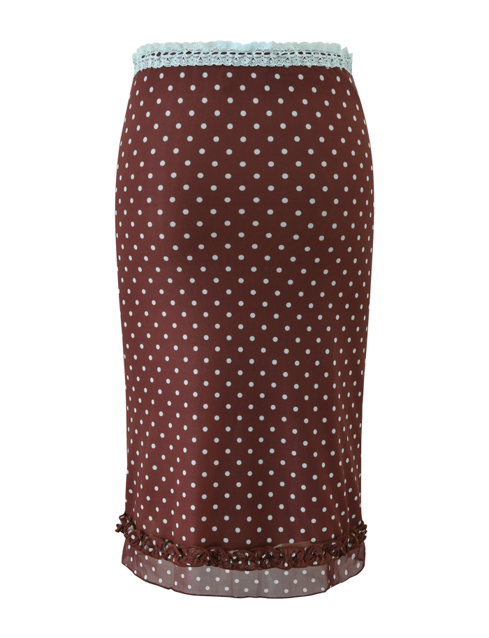 The TIGERMIST AMARA MIDI SKIRT - POLKA DOT is a brown knee-length mesh skirt with white dots, featuring light blue lace trim at the waistband and ruffled hem detailing.