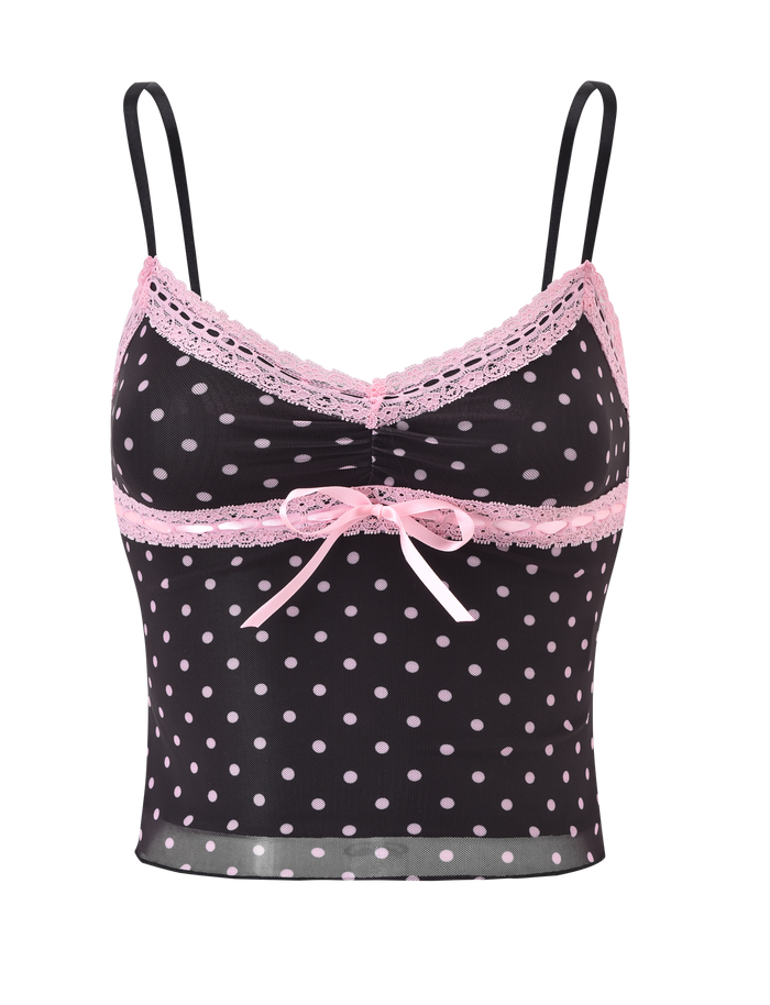 The AMARA TOP - BLACK by TIGERMIST is a black polka dot cami with light pink dots, lace trim on the neckline and straps, and a pink ribbon bow at the center front for a charming touch.
