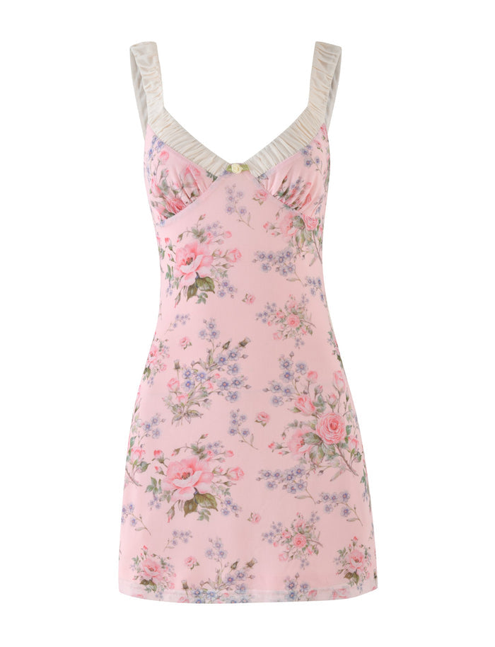 The AMARAN MINI DRESS - PINK : FLORAL : WILD FLOWER by TIGERMIST is a pink floral sleeveless mini dress that features a bustier-style fitted bodice and pleated shoulder straps. Adorned with a pattern of pink roses and small purple flowers against a light pink background, it exudes effortless elegance.