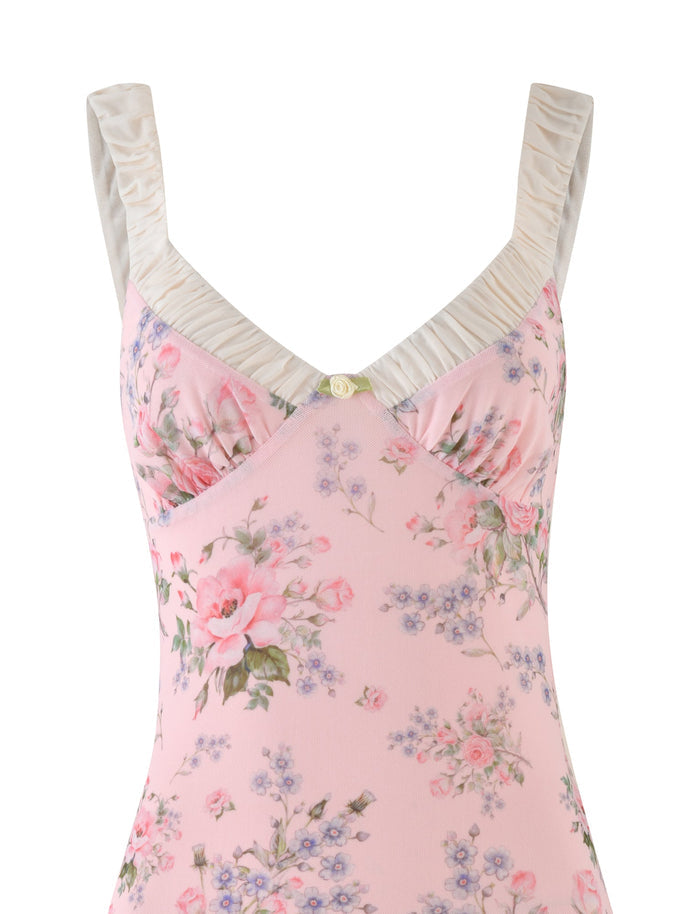 A close-up of the Tigermist Amaran Mini Dress in Wild Flower, showcasing a pink floral design with a V-neckline and ruched straps. This bustier-style fabric features an elegant pattern of flowers in shades of pink, lavender, and green.