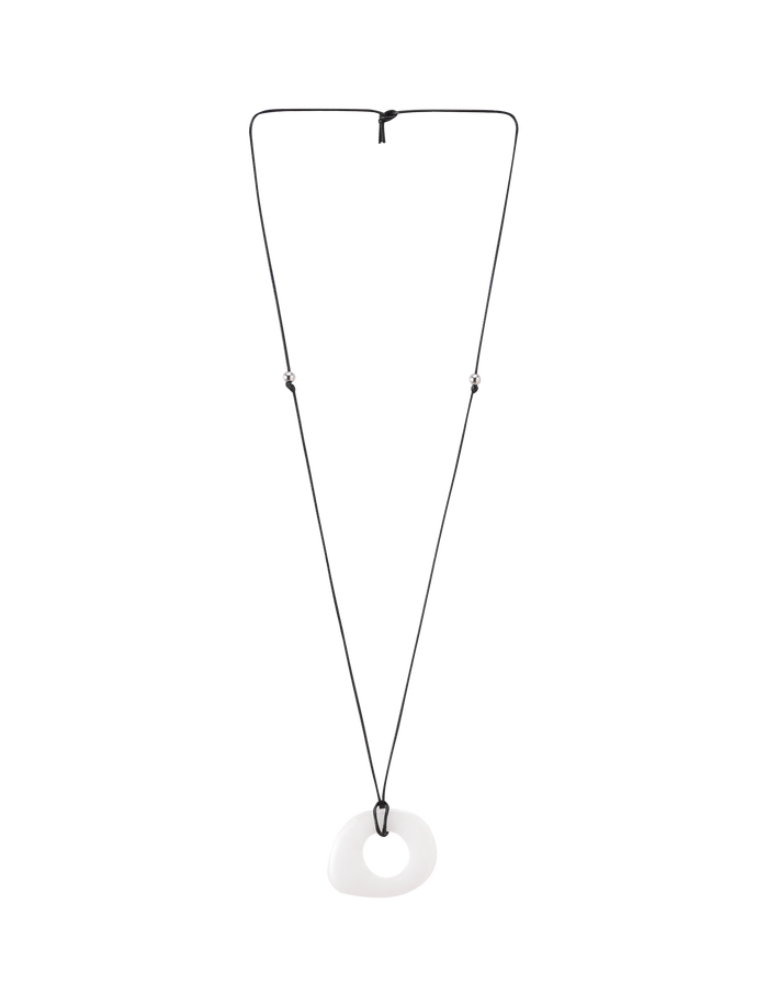 The TIGERMIST AMYRA PENDANT NECKLACE - WHITE features a smooth, white, asymmetrical resin donut-shaped pendant on a waxed cord with an adjustable knot for a minimalist look.