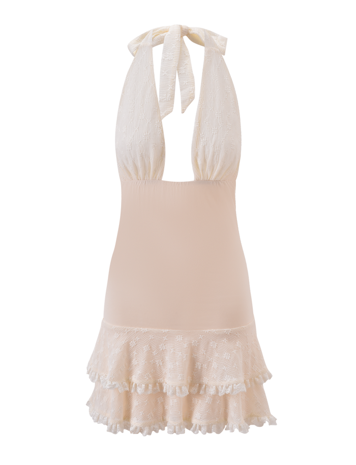 The ANOUK RUFFLE MINI DRESS by TIGERMIST is a sleeveless cream mini dress with a plunging halter neckline, tie-back straps, and fitted bodice. Its skirt features layered floral lace ruffles for a soft, feminine look.