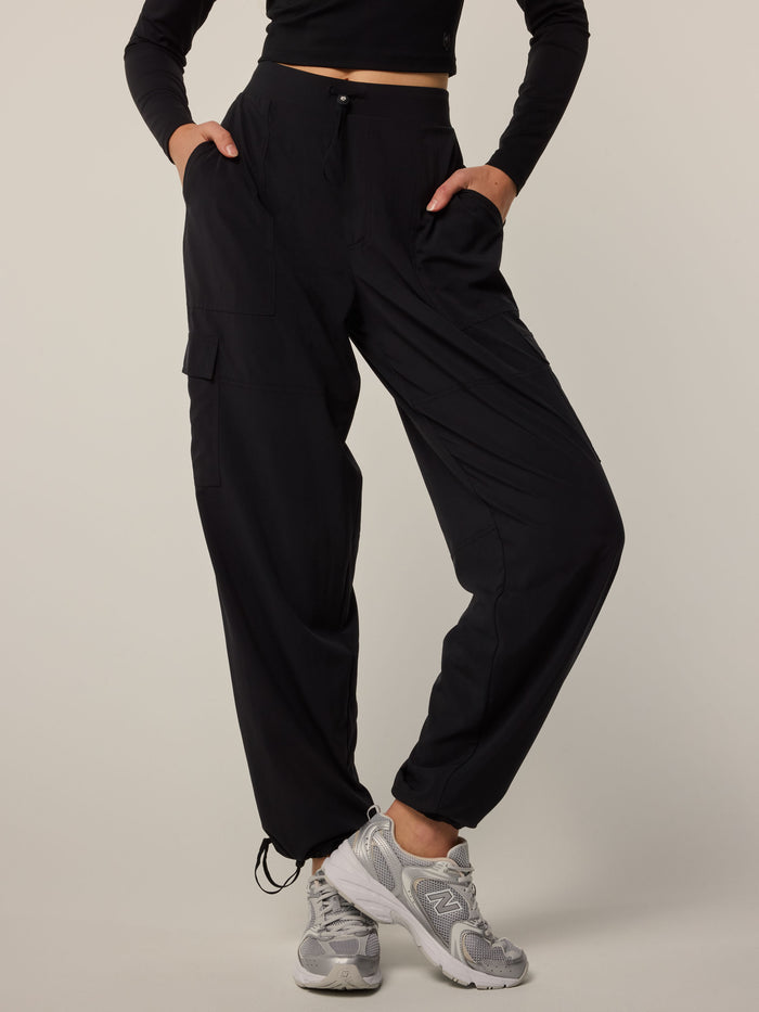 Black Greyson Clothiers Ashe Cargo Pant - On Model Front View, Side Cargo Pockets, Ankle Drawstring | Greyson Clothiers