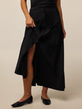 Greyson Clothiers Ashe Midi Skirt in Black - Button-Front Detail, Model Lifting Hem | Greyson Clothiers