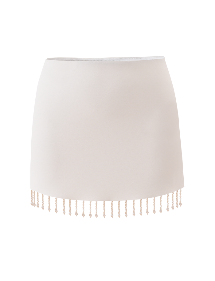 The TIGERMIST AUBRIELLA TASSLE MINI SKIRT in cream is a high-waisted, fitted mini skirt with a straight cut and delicate beaded tassel fringe along the hem. Photographed against a plain white background.