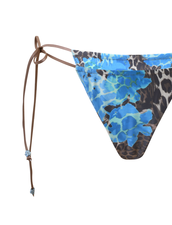 The TIGERMIST AVE BIKINI BOTTOM - BLUE LEOPARD is a classic low-rise bikini bottom with brown side tie strings, shown on a plain white background.