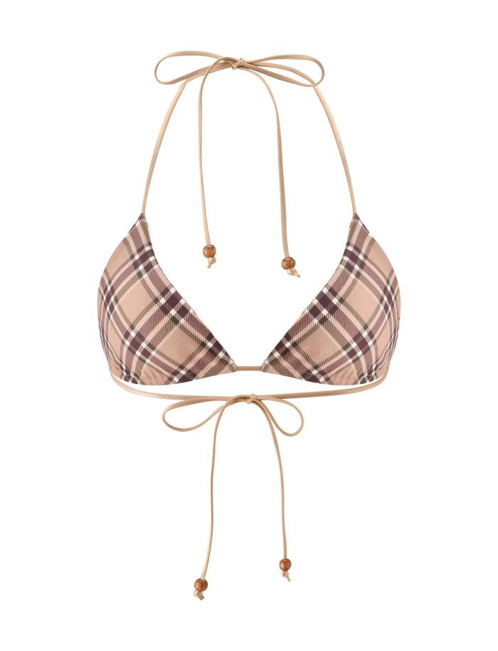 The AVE REVERSIBLE BIKINI TOP by TIGERMIST features a tan and pink plaid pattern with adjustable neck and back ties, finished with small wooden bead accents. This bikini top is shown on a white background.