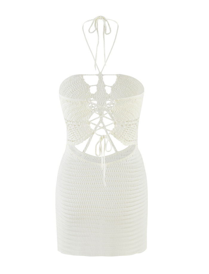 The TIGERMIST AZADI MINI DRESS in white is a crochet halter neck mini with an open back, lace-up detailing, and cut-out sections. Its form-fitting design ties at the neck and back for a flirty, feminine summer look.