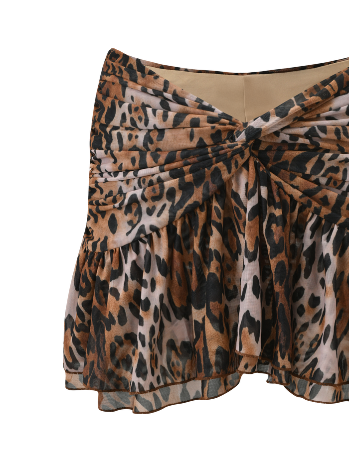 The TIGERMIST AZALEA TWIST MINI SKIRT - LEOPARD features a short, ruffled silhouette in brown, black, and beige leopard print with a twisted front knot and tiered flounce hem for playful movement.
