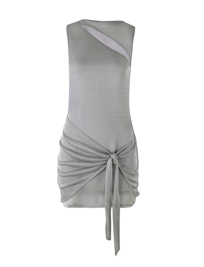 The AZELMA DRESS - SILVER by TIGERMIST is a sleeveless metallic knit mini dress with an asymmetrical neckline cutout, draped ruched waist, front tie knot, and fitted silhouette with a subtle sheen.