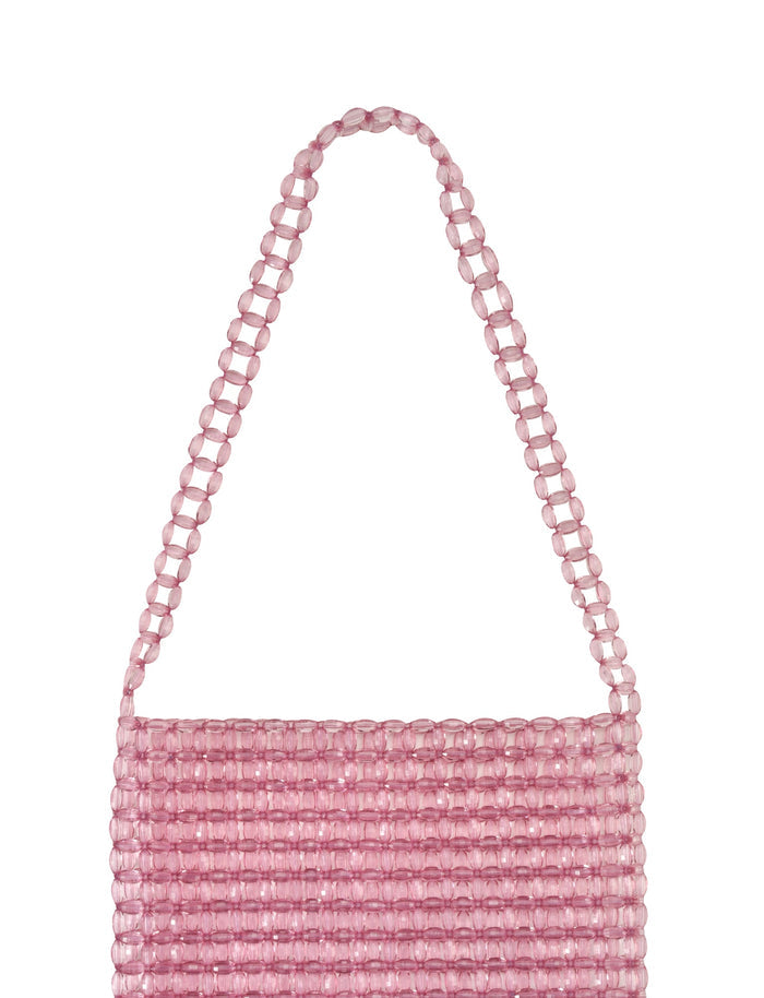 The medium-sized BIANKA BAG - PINK from TIGERMIST features a single handle and is crafted from pink clear lucite beads arranged in horizontal rows, giving it a textured and shimmering translucent appearance.