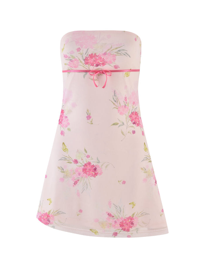 The TIGERMIST CARSYN MINI DRESS in watercolour floral features a strapless neckline with a pink floral pattern on a light background. It's accentuated by a pink ribbon at the waist and an asymmetrical hemline that enhances its feminine elegance, with butterflies and various flowers adding a whimsical touch.