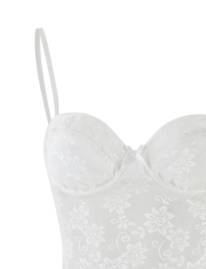 The CHARLEIGH TOP - WHITE : LACE by TIGERMIST is a white lace camisole bustier with spaghetti straps, floral patterns, a sweetheart neckline, and sheer fabric.
