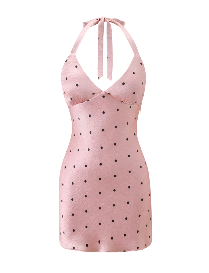 The CINCIE MINI DRESS - PINK DOT by TIGERMIST is a pink satin halter-neck mini dress with black polka dots, fitted at the waist and slightly flared at the hem, shown on a white background.