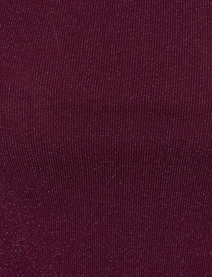 A close-up of the COBI MINI DRESS 2.0 - PURPLE by TIGERMIST showcases its textured fabric in a rich, dark maroon hue, featuring fine vertical lines and subtle sparkling details that evoke the shimmering effect of a glitter dress.