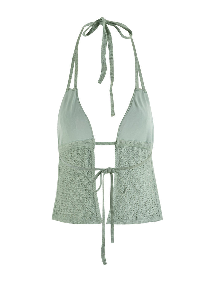 The COLLINA TOP - GREEN by TIGERMIST is a light green crochet top featuring an adjustable bust and tie closures at both the neck and front. It showcases a partially open front with intricate lace detailing on the lower portion, and is made from high-stretch fabric for enhanced comfort and fit.