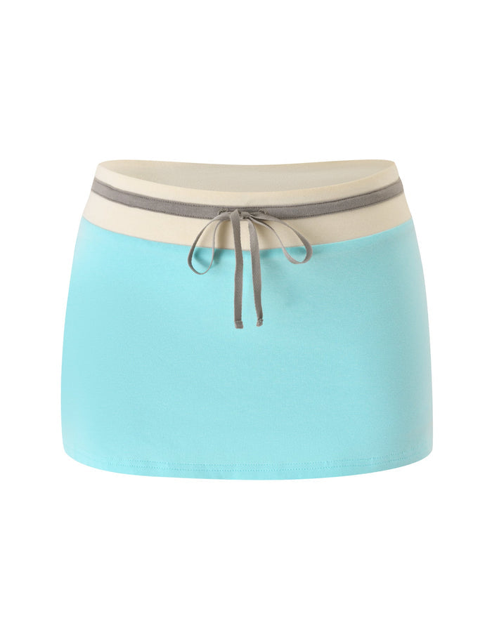 The COLLINS MINI SKORT - AQUA by TIGERMIST is a comfortable light aqua blue skort featuring a beige waistband and a gray front tie string, shown photographed against a white background.