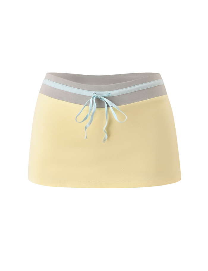 The TIGERMIST COLLINS SKORT in butter yellow features a contrasting light grey and blue waistband with a blue drawstring tie, shown against a plain white background.