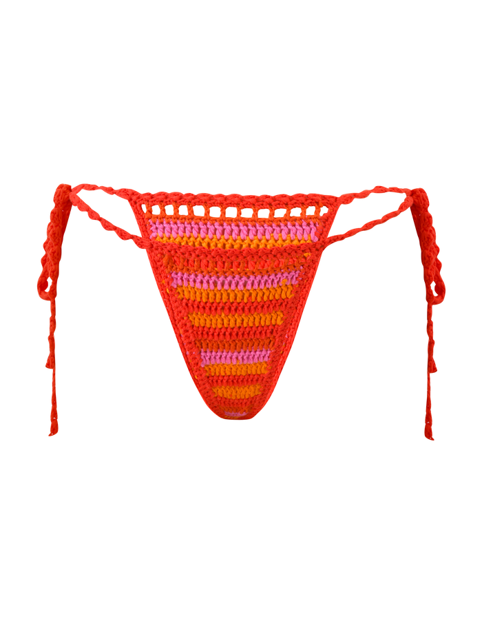 The TIGERMIST CORA BIKINI BOTTOM - SUNSET TROPICAL STRIPE features handmade red, orange, and pink crochet stripes, side ties, and a triangular front panel, displayed on a plain white background.