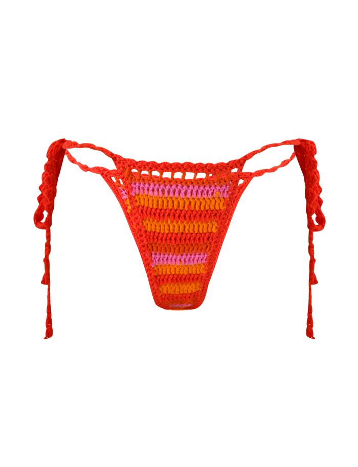 The CORA BIKINI BOTTOM - SUNSET TROPICAL STRIPE by TIGERMIST features cheeky red side ties and bold orange and pink stripes on a vibrant crochet design, shown against a plain white background.