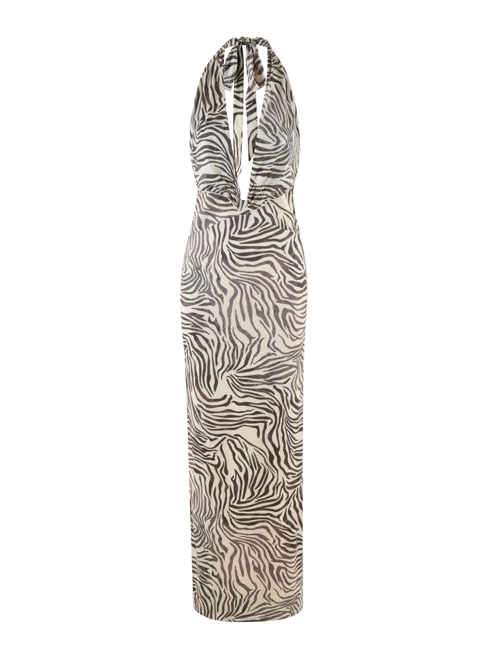 The CRESSIDA DRESS - NEUTRAL : ZEBRA by TIGERMIST is a sleeveless halter neck dress with a plunging neckline and an all-over black and white zebra print.
