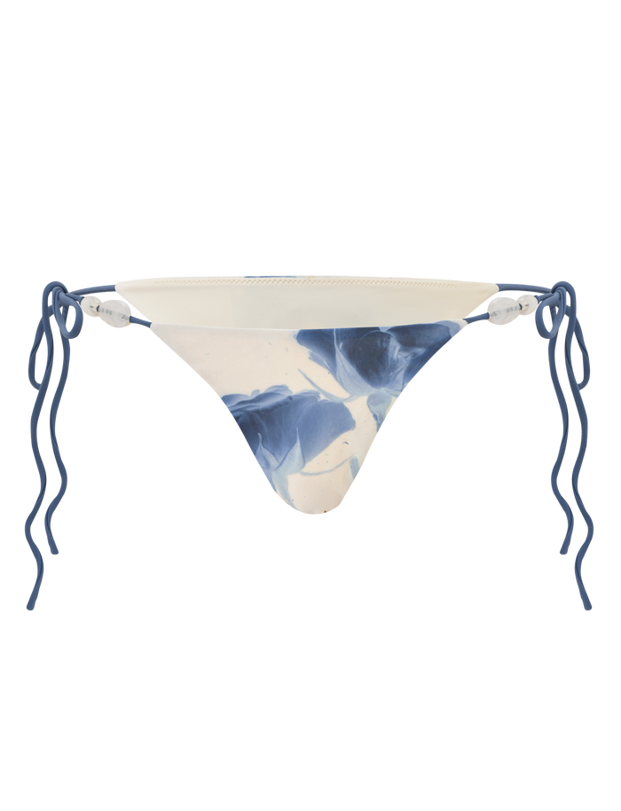 The TIGERMIST CYLAS Bikini Bottom in Indigo Floral features blue rose-inspired abstract patterns, reminiscent of wavy accents, displayed on a white background.
