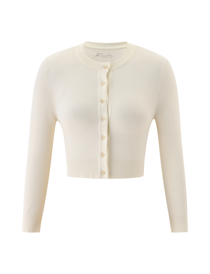 The DAMARIS CARDIGAN - CREAM by TIGERMIST is a cream knit, long-sleeve, cropped cardigan with a round neck and front button closure, shown on a plain white background.