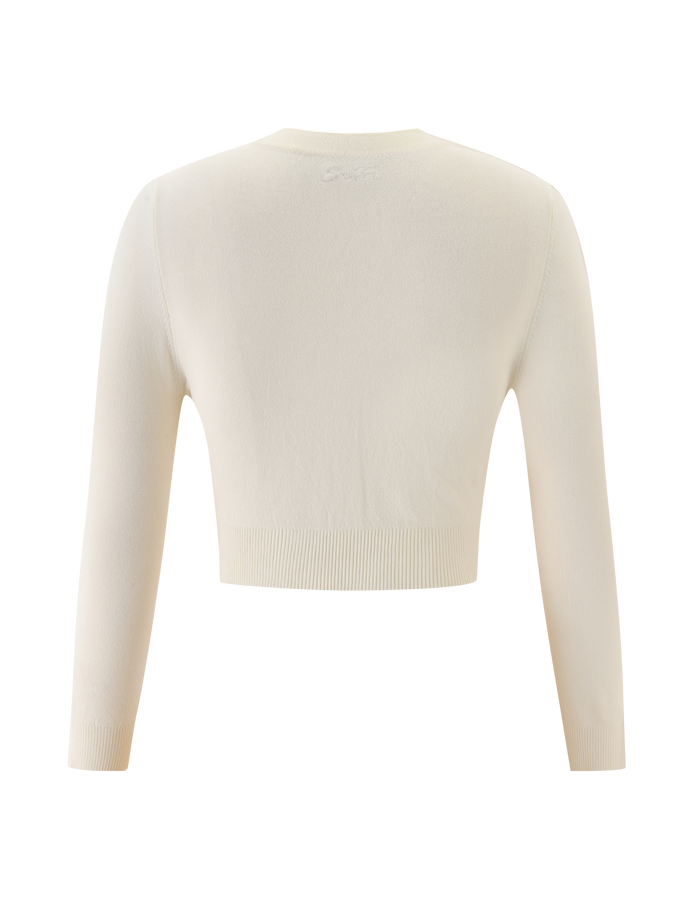 Back view of the TIGERMIST DAMARIS CARDIGAN in cream, featuring a long-sleeve, cropped knit silhouette against a white background.