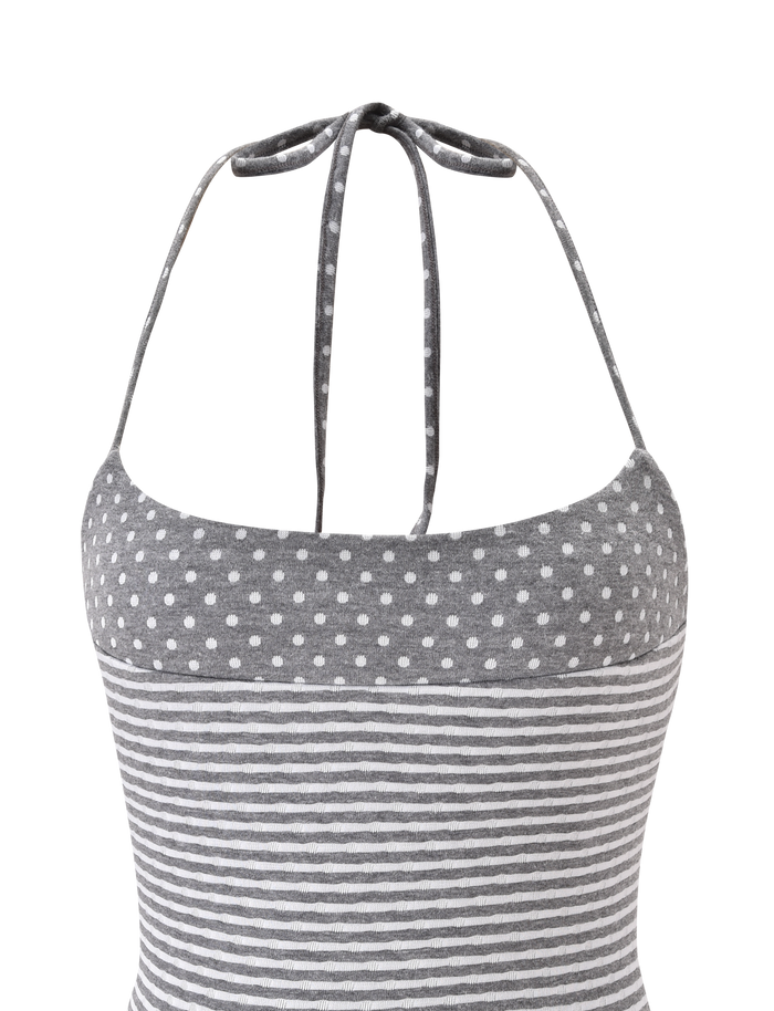 The DASHIELL TOP by TIGERMIST in heather grey features a rib knit halter neck with playful polka dots above horizontal white stripes, shown from the back against a plain white background.
