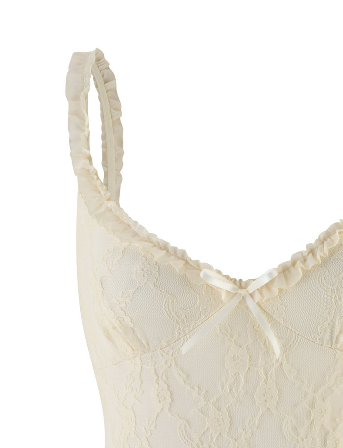 Close-up of the TIGERMIST DEJA BODYSUIT in beige champagne lace, showcasing mesh ruffled shoulder straps and a satin bow at the neckline.