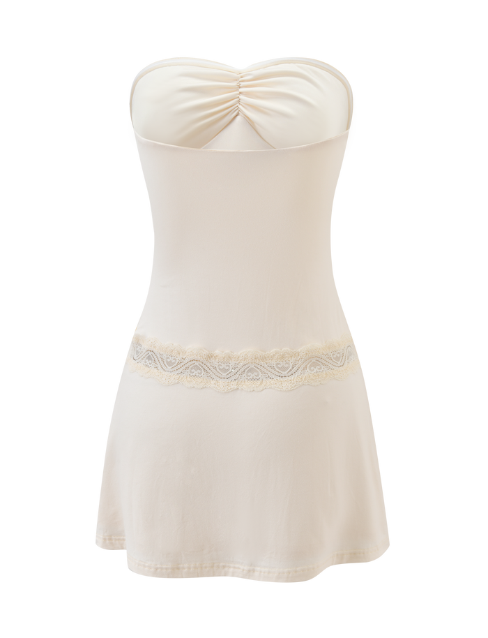 The DELARA DRESS - CREAM by TIGERMIST is a strapless, figure-hugging mini dress with a ruched bust and delicate lace waist insert, shown against a plain white background.
