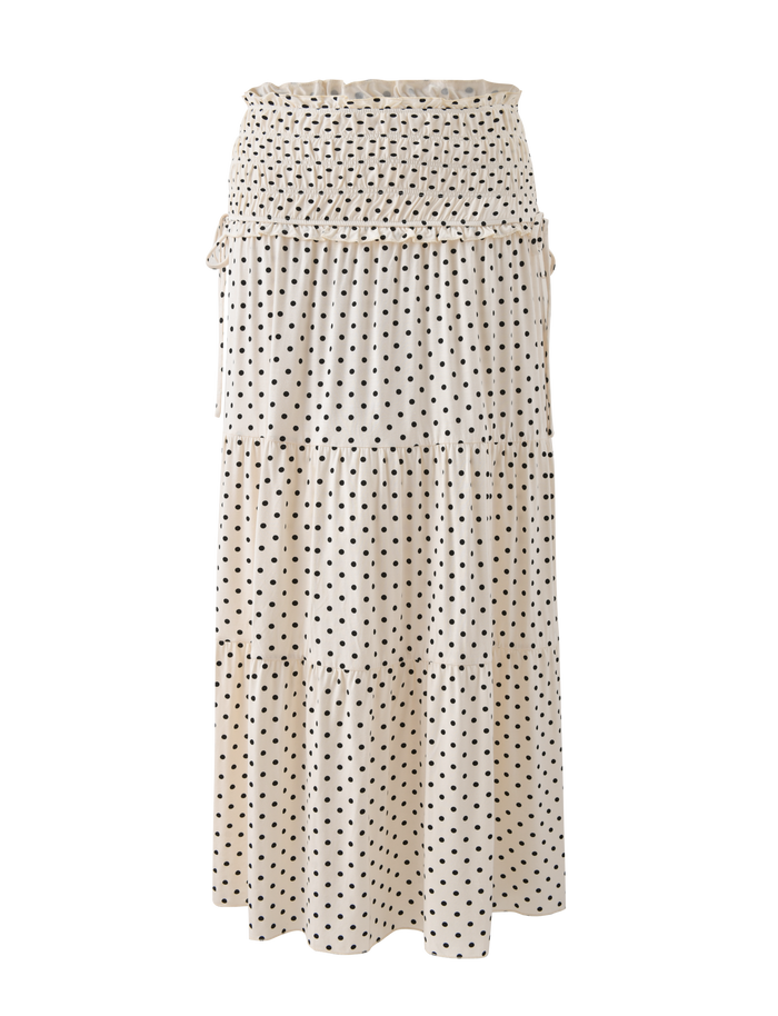 The TIGERMIST DENALI MAXI SKIRT - CREAM DOT is a cream polka dot, tiered maxi skirt with a smocked waistband, made from soft modal fabric and shown on a white background.