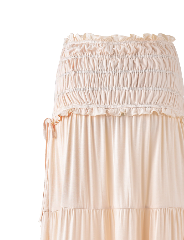 A close-up of the TIGERMIST DENALI MAXI SKIRT in Neutral: Bone, featuring a soft, lightweight fabric with a flowy, tiered silhouette and elegant flare—perfect for standout style.