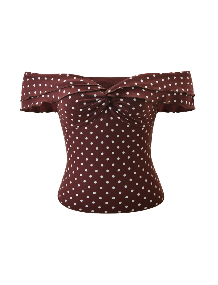 The DENALI TOP - BROWN DOT by TIGERMIST features a stylish off-shoulder design with polka dots, a knotted front, ruffled sleeves, and is crafted from soft modal fabric for superior comfort.