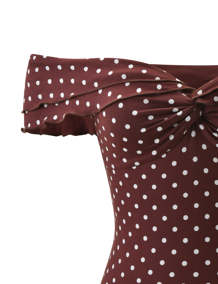 Close-up of the TIGERMIST DENALI TOP - BROWN DOT, an off-shoulder maroon top with white polka dots, twisted knot at the bust, and ruffled modal neckline for a feminine touch.