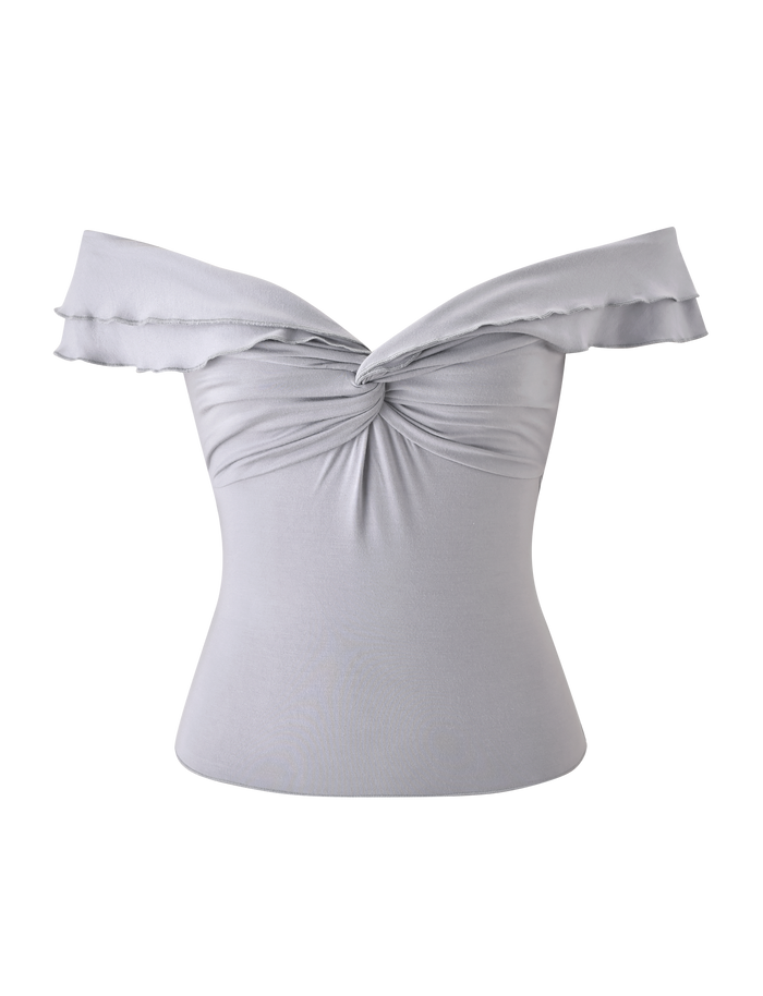 The DENALI TOP in dove grey by TIGERMIST is an off-the-shoulder, soft modal top with a front twisted knot and ruffled sleeves, displayed against a white background.