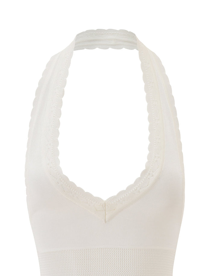 A close-up of the DENI HALTER - CREAM by TIGERMIST, featuring a ribbed knit texture, scalloped trim, and plunging V neckline, displayed on a plain white background.