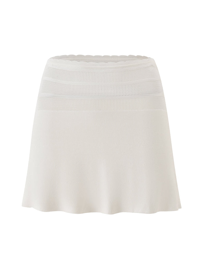 The DENI MINI SKIRT - CREAM by TIGERMIST is an elegant cream A-line knit skirt designed with horizontal mesh panels near the waistband and a subtle scalloped edge at the top. Its soft, flowing silhouette and textured, slightly stretchy fabric offer ultimate comfort while maintaining a sophisticated shape—perfect for summer wear.