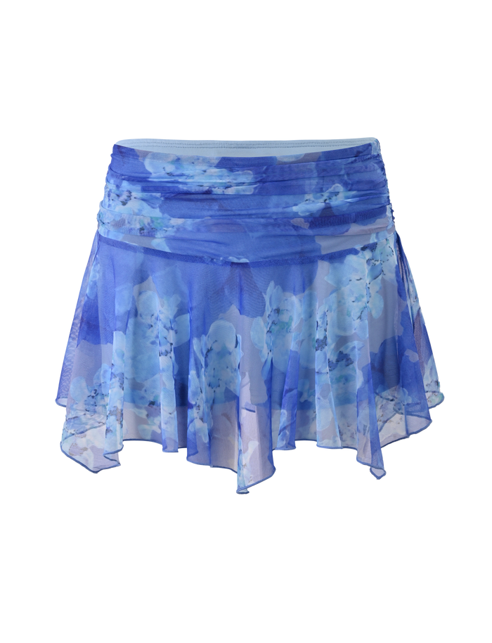 The DEVYN MINI SKORT by TIGERMIST features a blue macro floral print, asymmetric hem, and flowy, lightweight stretch fabric.