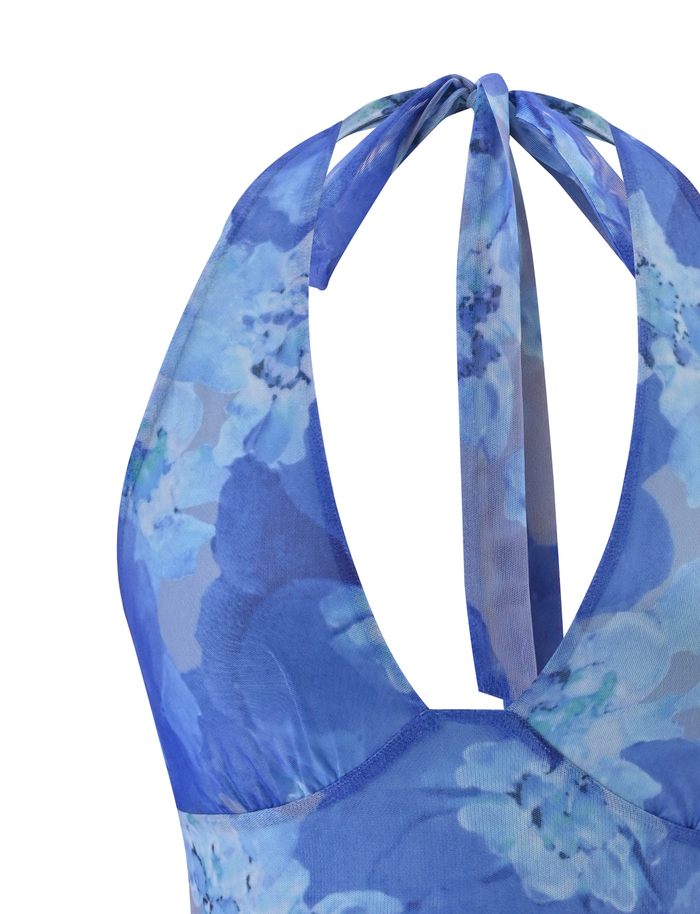 Close-up of the back of the TIGERMIST DEVYN TOP in Blue Macro Floral, featuring crisscrossed halter neck straps and high-stretch fabric with a watercolor-style blue floral pattern.