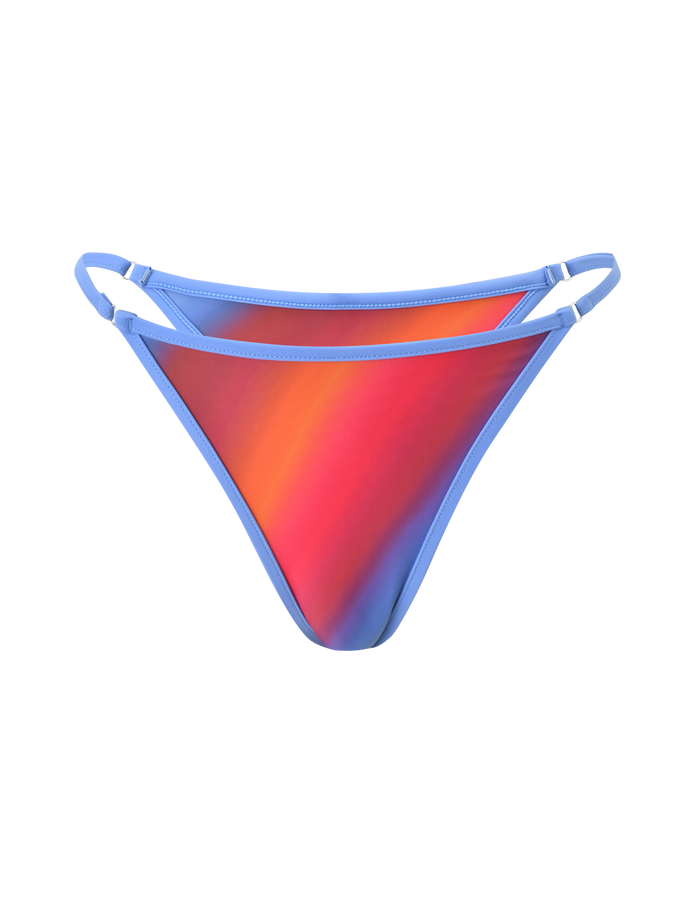 The DIANA SWIM SKIRT SET - CIELO OMBRE by TIGERMIST showcases a bikini bottom with a red, orange, and blue ombre stripe gradient and light blue double side straps, set against a plain white background.