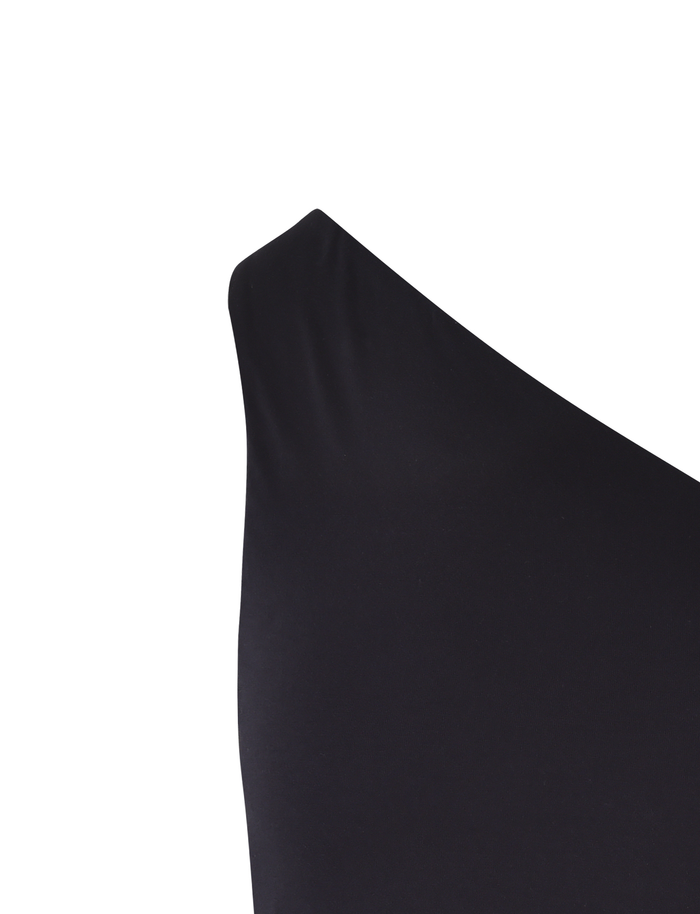 Close-up of the TIGERMIST DREW TOP - BLACK against a white background. The fitted fabric enhances its bodycon silhouette and emphasizes the bold asymmetric one-shoulder neckline.