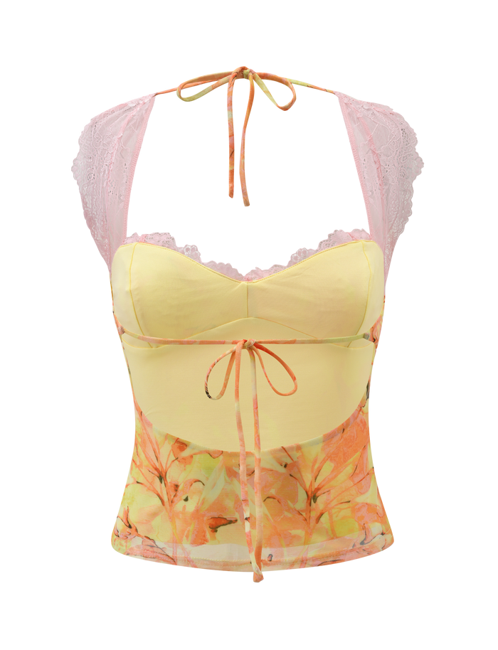 The TIGERMIST DUNE MESH TOP - CREAMSICLE is a sleeveless, floral-patterned camisole with a yellow bodice, pink lace straps, and orange ribbon ties at the bust and waist, vividly displayed on a white background.