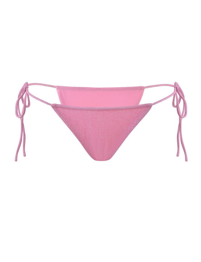 The TIGERMIST ELLISON BIKINI BOTTOM in baby pink features a shimmer finish, low-rise waist, and adjustable side ties, shown against a light pink background.