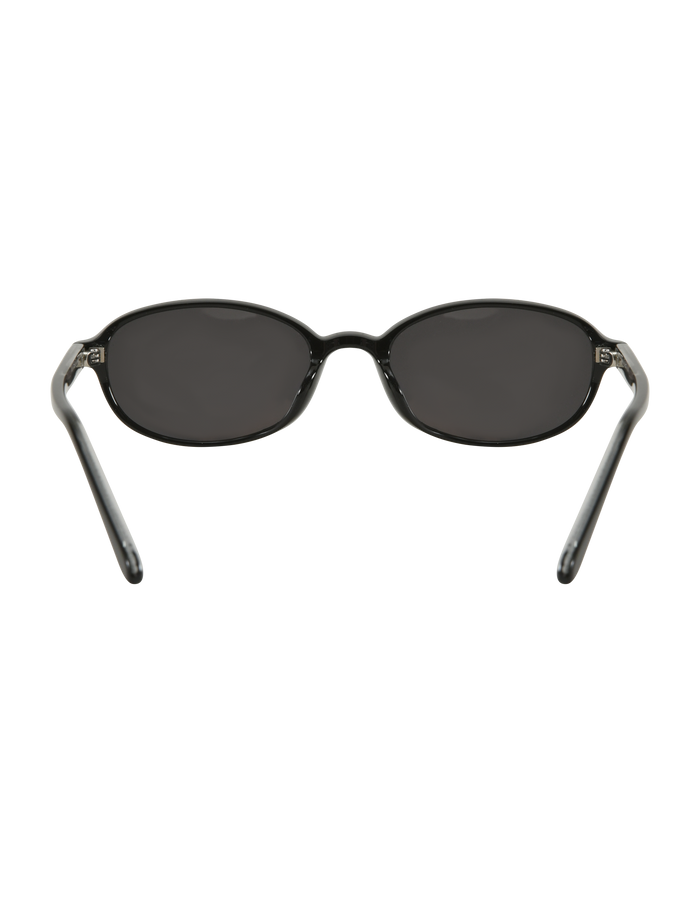 The ESTA GLASSES - BLACK by TIGERMIST are black oval sunglasses with UV400 protection, dark lenses, and slightly curved temples, shown on a white background.